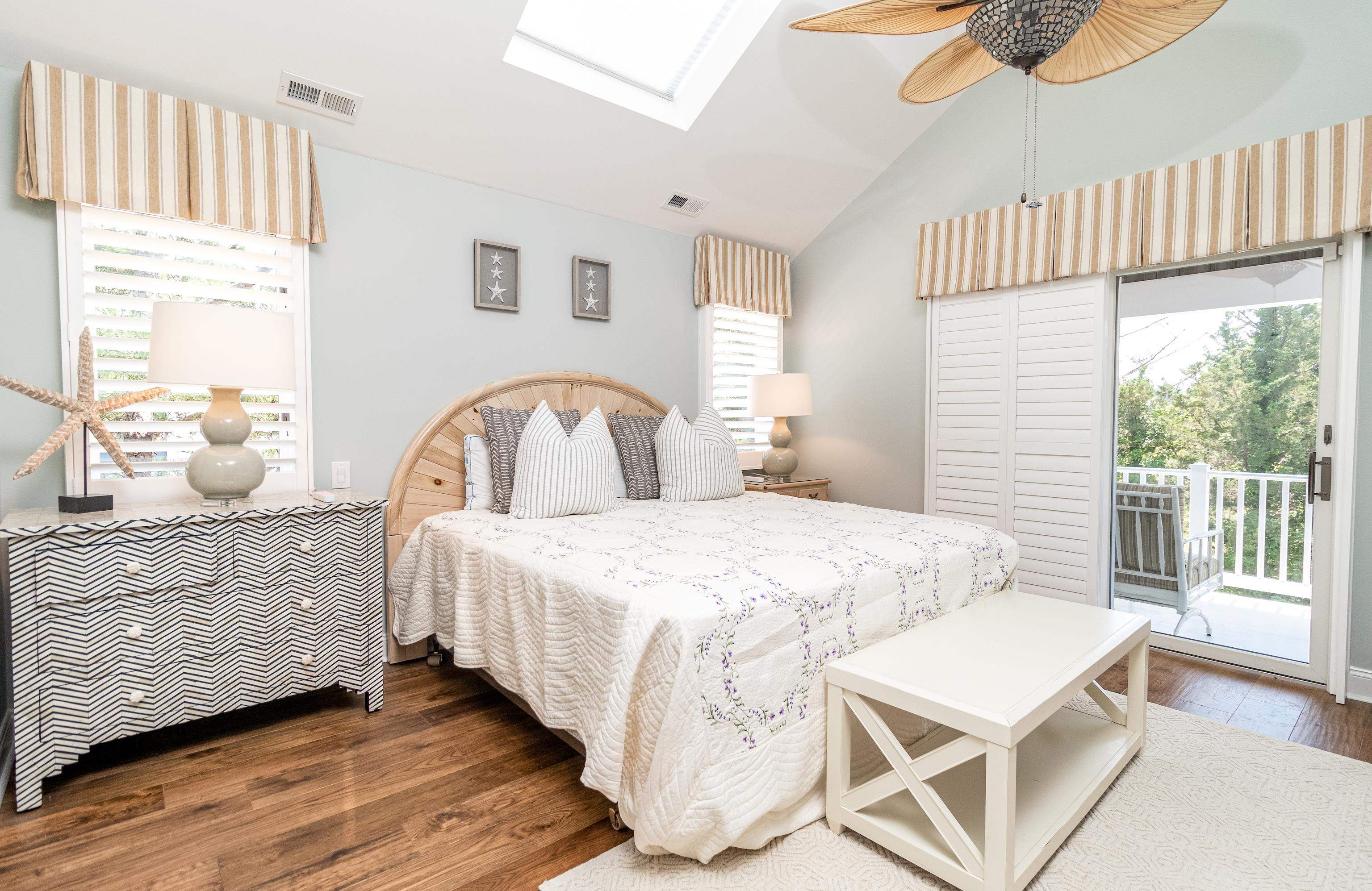178 37th Street Avalon, NJ 08202 - Photo 22 of 26 a bedroom with a bed a large window and wooden floor