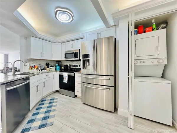 a kitchen with stainless steel appliances granite countertop a sink and cabinets