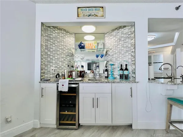 a living room with furniture and kitchen view