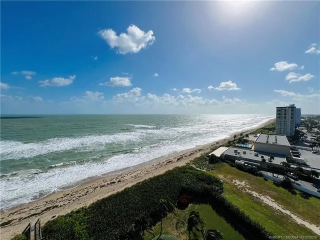 a bathroom with a granite countertop sink mirror vanity and toilet