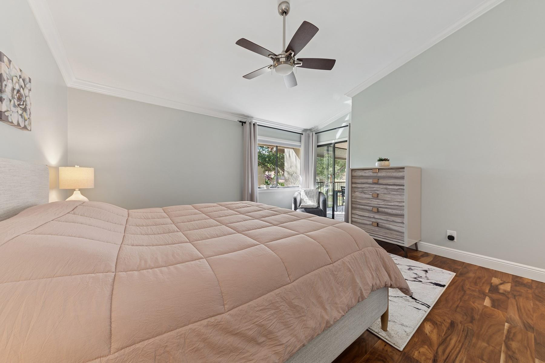 5560 Coach House Circle, Unit C Boca Raton, FL 33486 - Photo 12 of 19 a bedroom with a bed and ceiling fan
