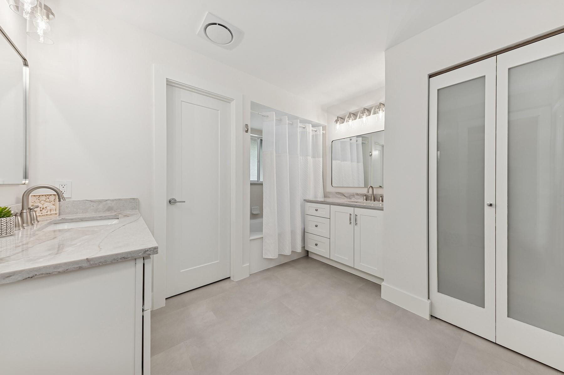 5560 Coach House Circle, Unit C Boca Raton, FL 33486 - Photo 13 of 19 a bathroom with a sink and a mirror