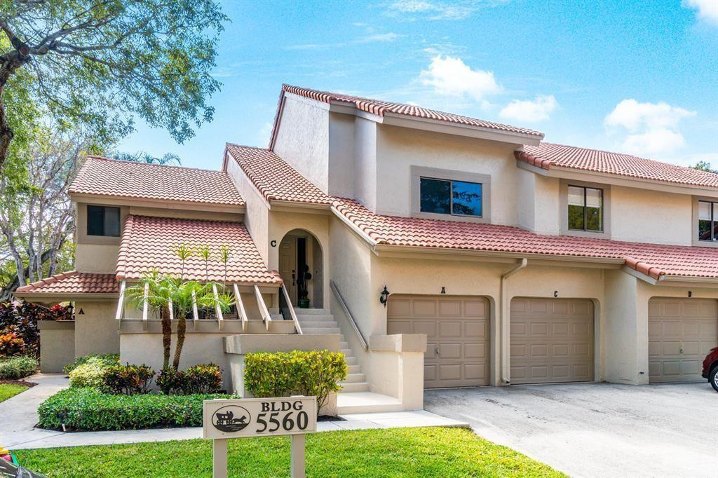 5560 Coach House Circle, Unit C Boca Raton, FL 33486 - Photo 2 of 19 a front view of a house with garden