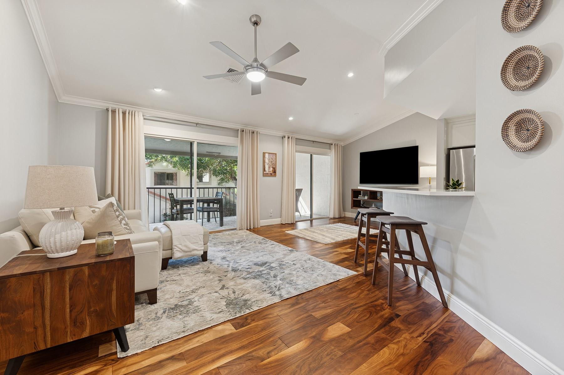 5560 Coach House Circle, Unit C Boca Raton, FL 33486 - Photo 5 of 19 a living room with furniture and a flat screen tv