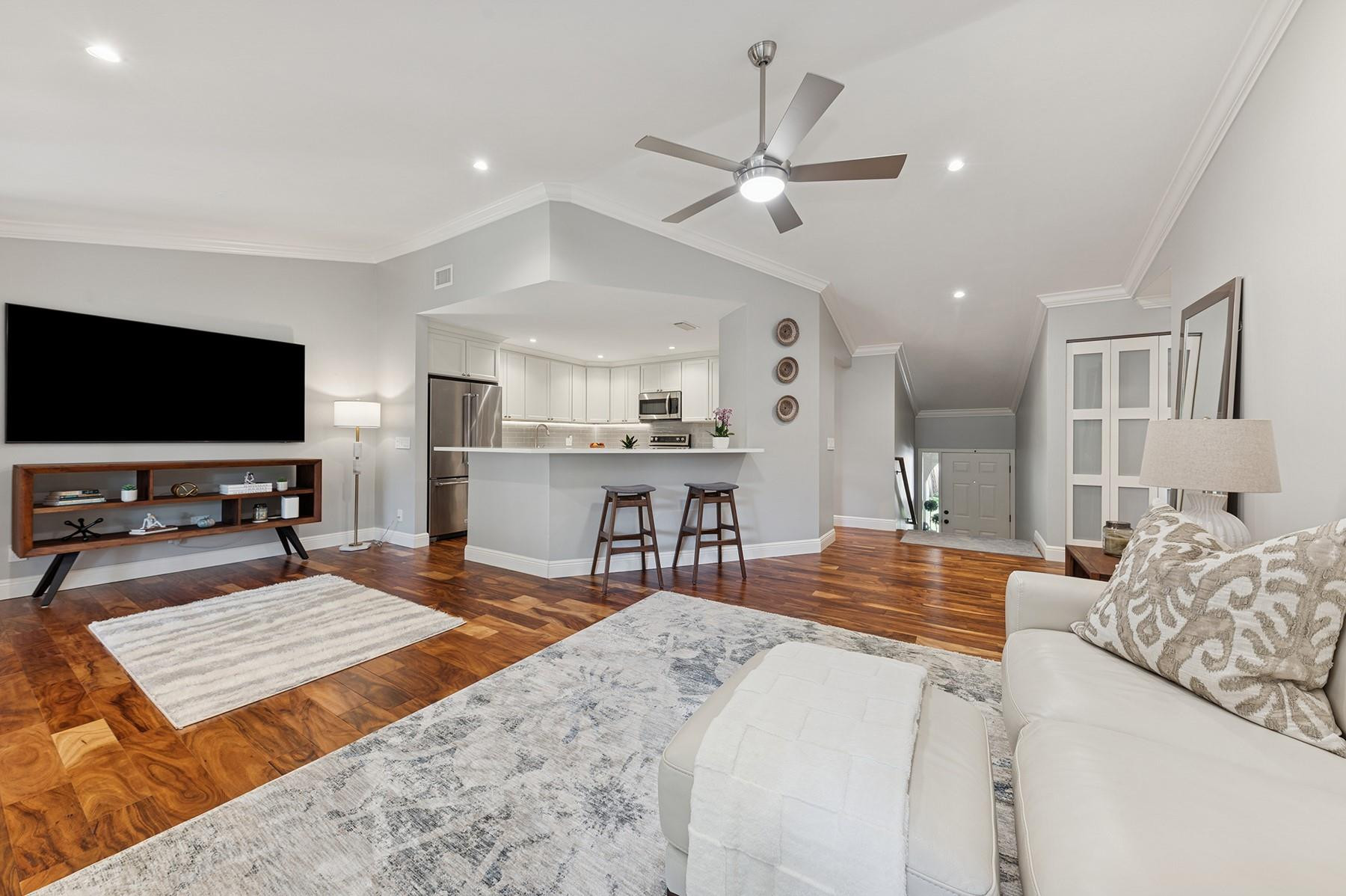 5560 Coach House Circle, Unit C Boca Raton, FL 33486 - Photo 6 of 19 a living room with furniture and a flat screen tv