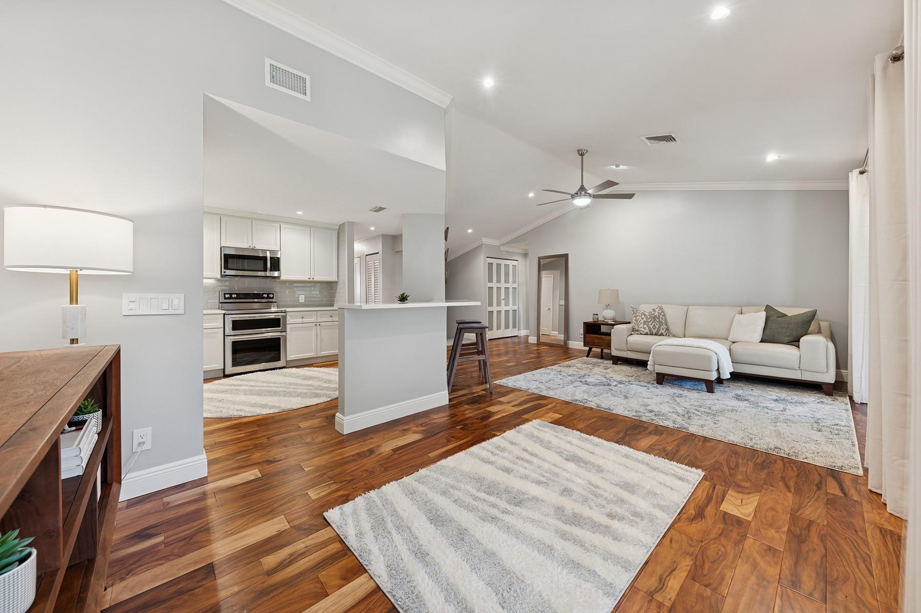 5560 Coach House Circle, Unit C Boca Raton, FL 33486 - Photo 7 of 19 a living room with furniture and a wooden floor