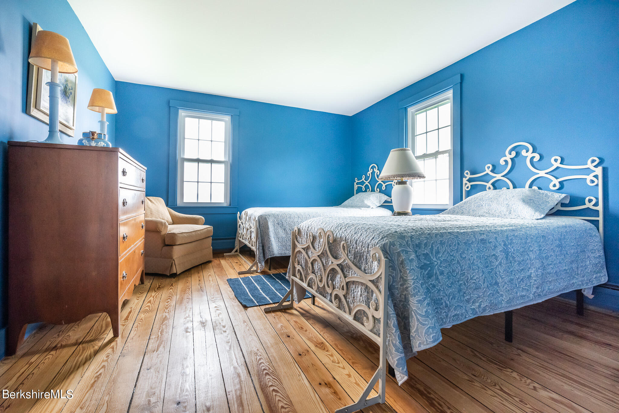 206 Blue Hill Road Great Barrington, MA 01230 - Photo 19 of 27 a bedroom with a bed and wooden floor