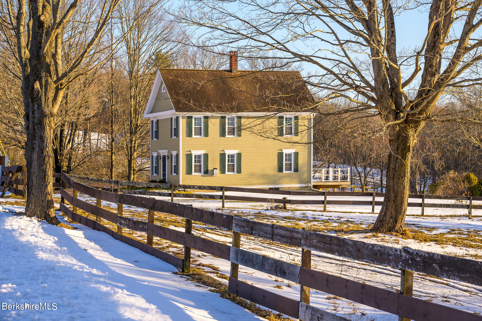 206 Blue Hill Road Great Barrington, MA 01230 - Photo 3 of 27 a view of a house with a yard covered with snow in the background