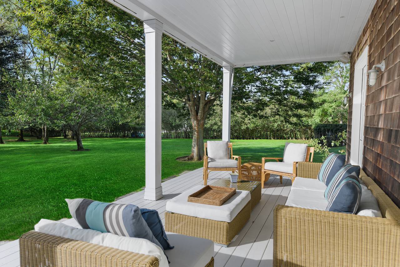 244 Flying Point Road Water Mill, NY 11976 - Photo 16 of 22 a view of a patio with couches chairs and a big yard