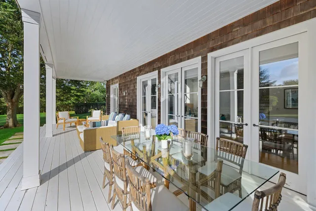 a view of balcony with chairs and wooden floor