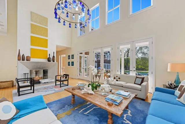 a living room with patio furniture and a large window