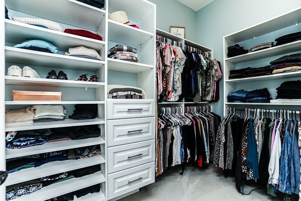 27 Pine Tree Drive, Unit 27 Methuen, MA 01844 - Photo 17 of 39 a view of walk in closet with clothes and shoes