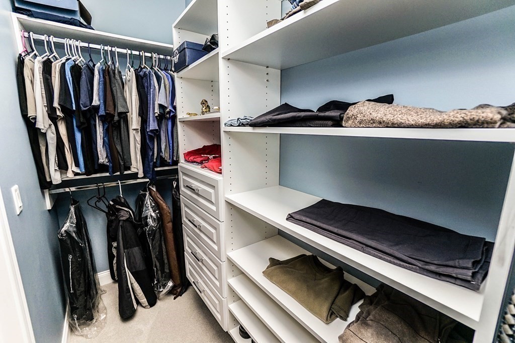 27 Pine Tree Drive, Unit 27 Methuen, MA 01844 - Photo 18 of 39 a view of walk in closet with clothes and shoes
