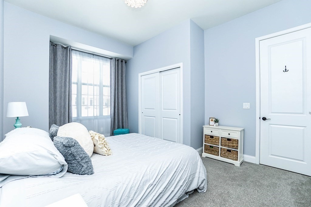 27 Pine Tree Drive, Unit 27 Methuen, MA 01844 - Photo 19 of 39 a bedroom with a bed and a window