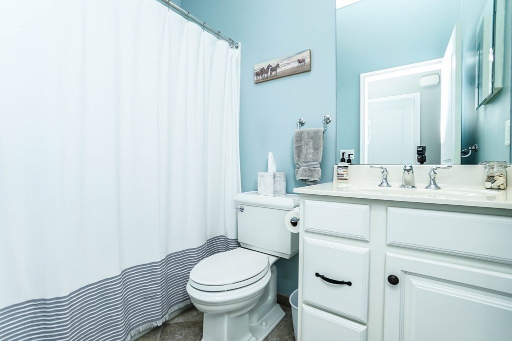 27 Pine Tree Drive, Unit 27 Methuen, MA 01844 - Photo 21 of 39 a bathroom with a sink a toilet and mirror