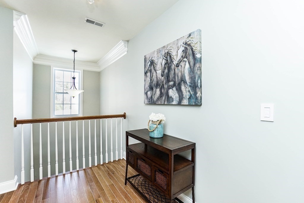 27 Pine Tree Drive, Unit 27 Methuen, MA 01844 - Photo 29 of 39 a view of a hallway with wooden floor and a bathroom