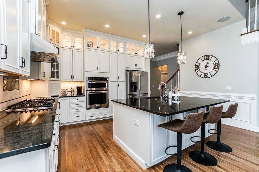 27 Pine Tree Drive, Unit 27 Methuen, MA 01844 - Photo 3 of 39 a kitchen with stainless steel appliances kitchen island granite countertop a stove a refrigerator a oven a sink with a dining table and chairs