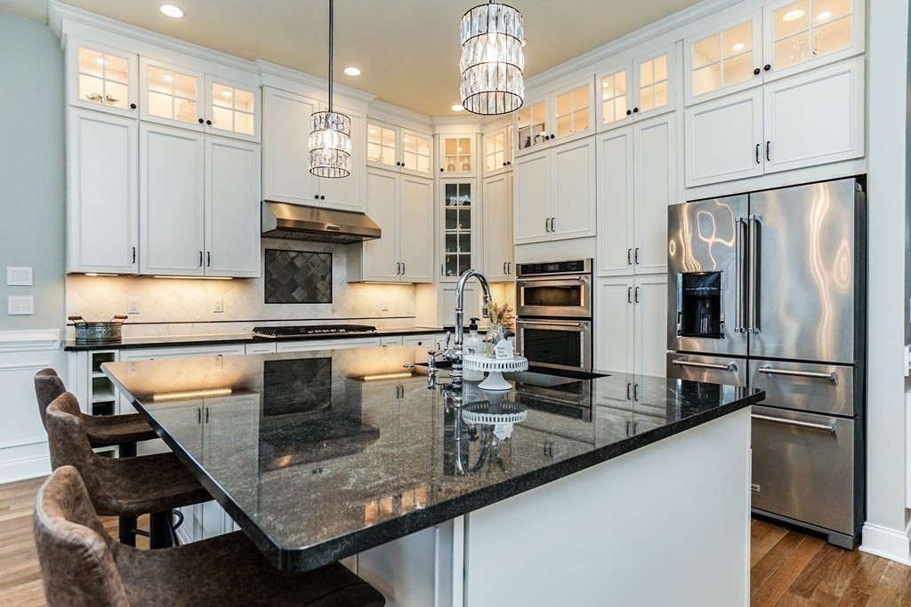 27 Pine Tree Drive, Unit 27 Methuen, MA 01844 - Photo 4 of 39 a kitchen with kitchen island a counter appliances a sink and cabinets