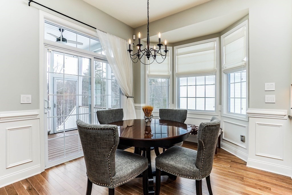 27 Pine Tree Drive, Unit 27 Methuen, MA 01844 - Photo 6 of 39 a view of a dining room with furniture a chandelier and wooden floor