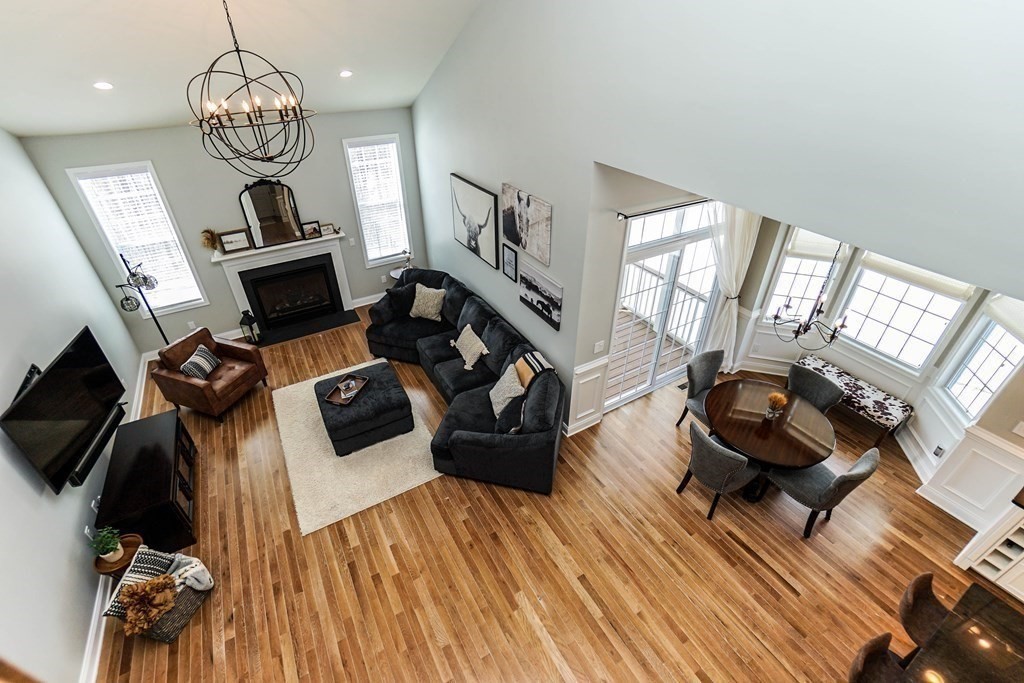 27 Pine Tree Drive, Unit 27 Methuen, MA 01844 - Photo 7 of 39 a living room with furniture and a chandelier