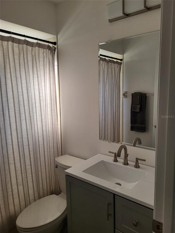 482 Pendleton Place Venice, FL 34292 - Photo 28 of 54 a bathroom with a toilet a sink and mirror