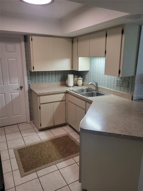 482 Pendleton Place Venice, FL 34292 - Photo 30 of 54 a kitchen with a sink a stove and cabinets