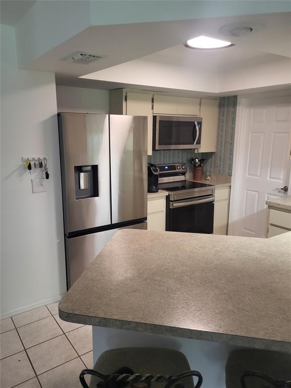 482 Pendleton Place Venice, FL 34292 - Photo 32 of 54 a kitchen with stainless steel appliances a refrigerator and a stove top oven
