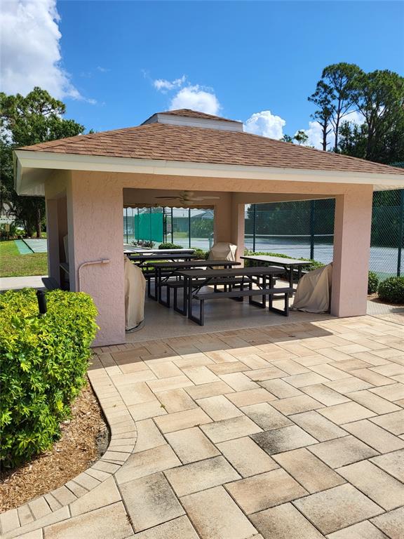 482 Pendleton Place Venice, FL 34292 - Photo 51 of 54 a view of a patio with table and chairs with potted plants