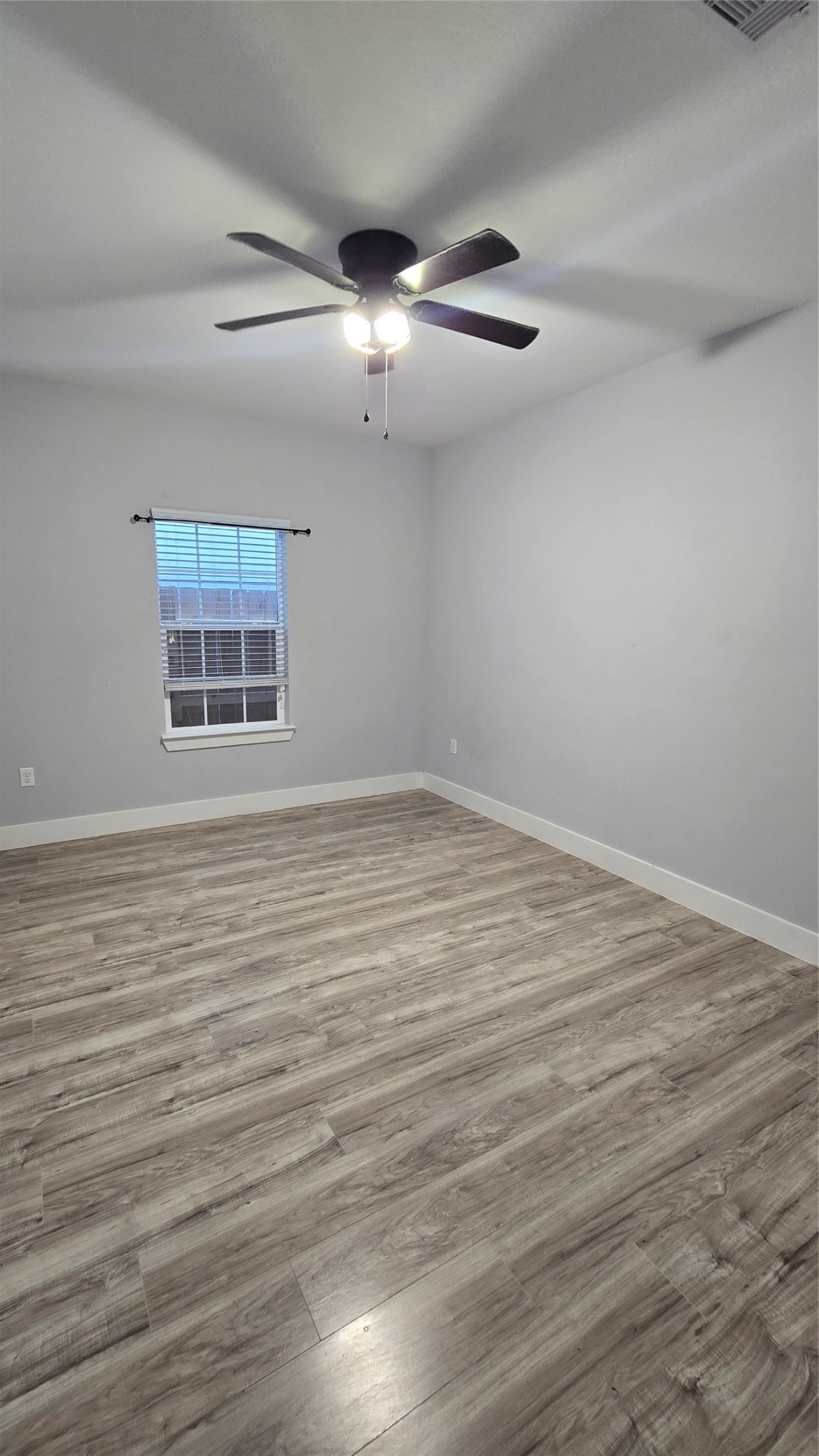 10017 Morocco Road Houston, TX 77041 - Photo 14 of 24 an empty room with wooden floor and windows