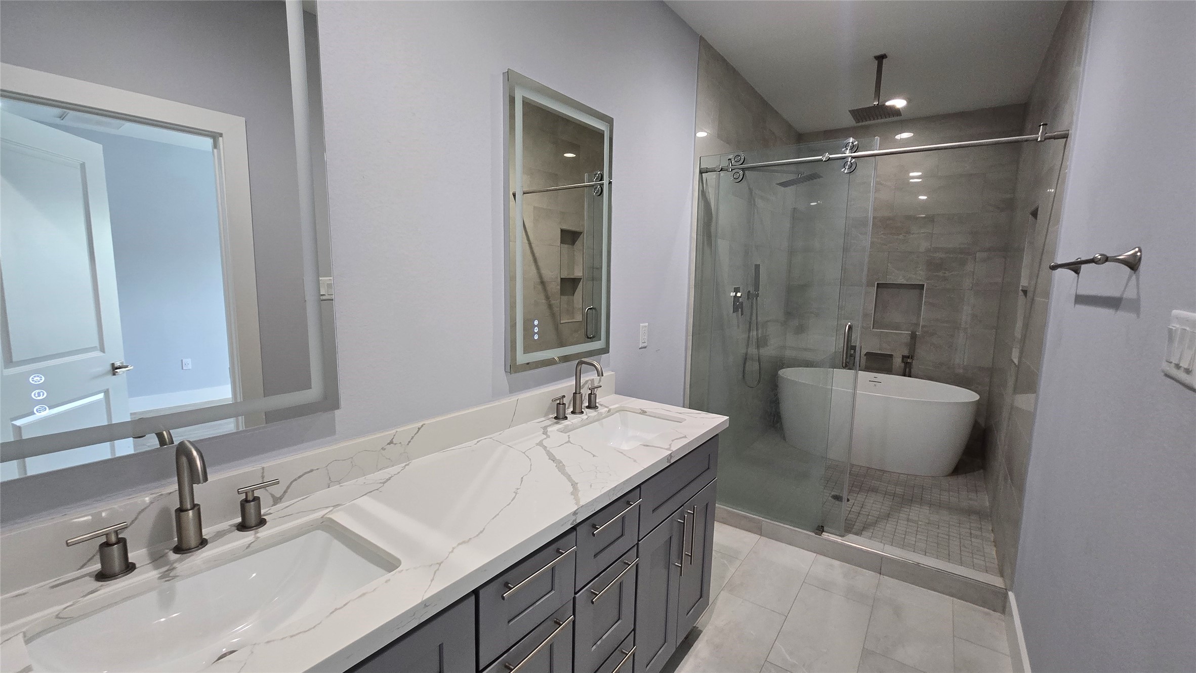 10017 Morocco Road Houston, TX 77041 - Photo 21 of 24 a bathroom with a double vanity sink a mirror and a bathtub