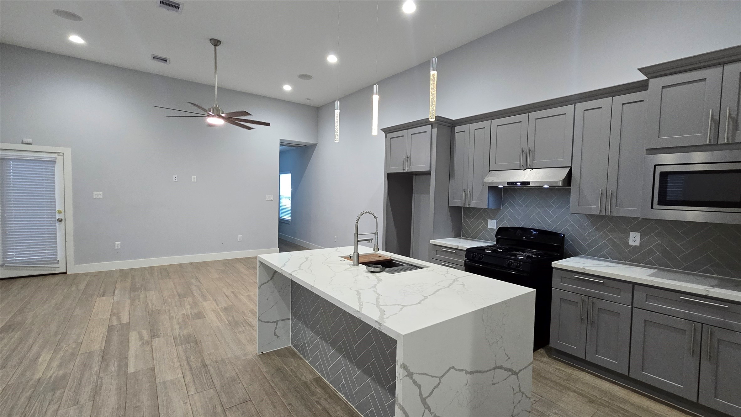 10017 Morocco Road Houston, TX 77041 - Photo 4 of 24 a kitchen with a sink a stove a refrigerator and cabinets