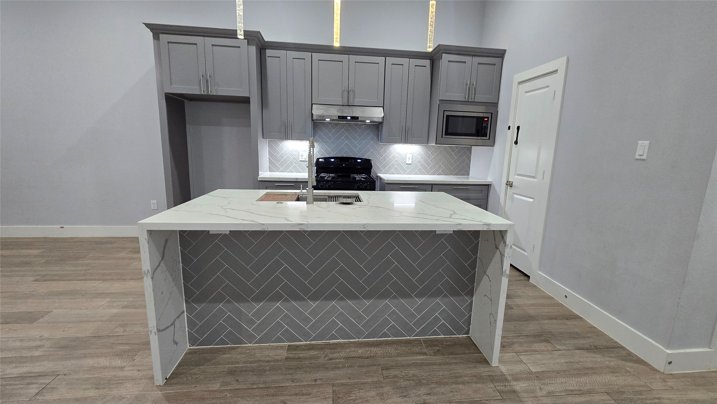 10017 Morocco Road Houston, TX 77041 - Photo 8 of 24 a kitchen with a wooden floor and cabinets