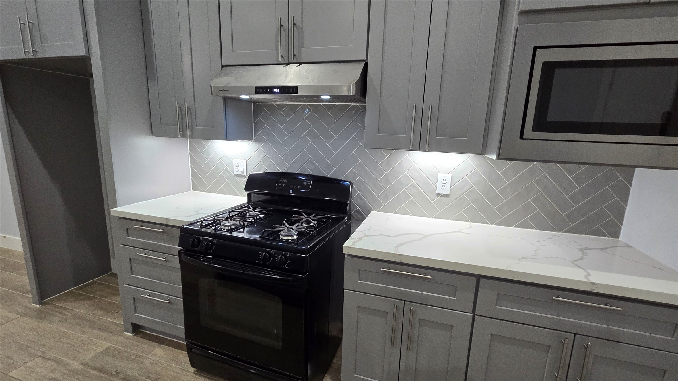 10017 Morocco Road Houston, TX 77041 - Photo 9 of 24 a kitchen with stainless steel appliances granite countertop a stove and a microwave