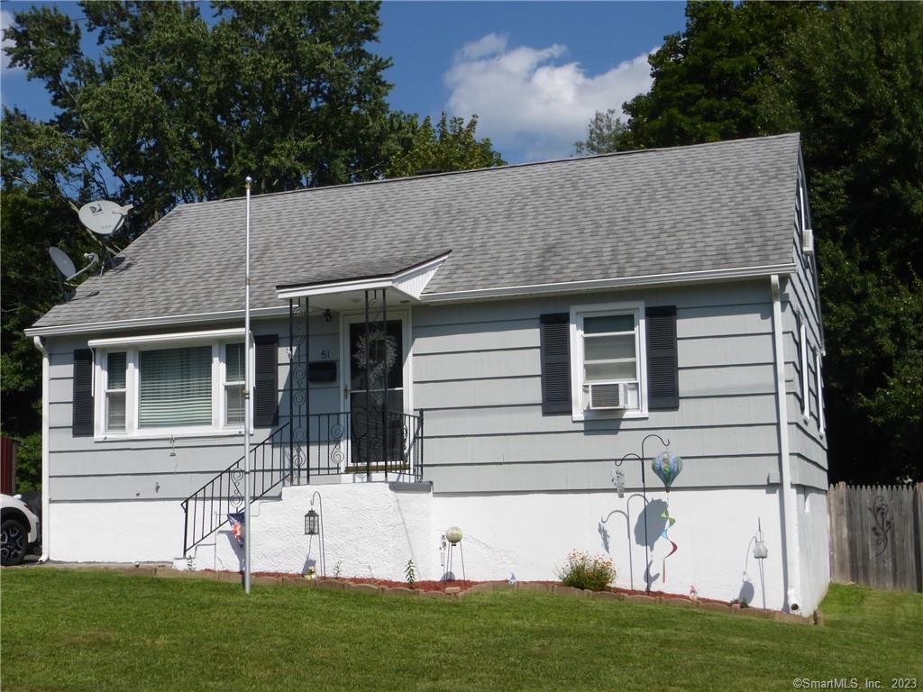 a view of house with a yard