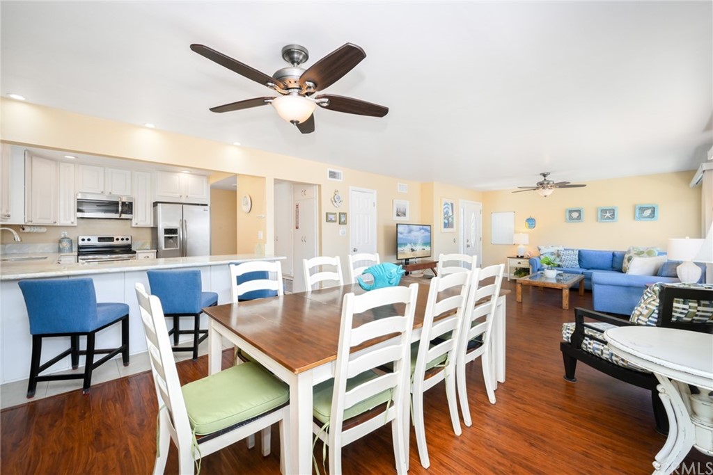 5100 Seashore Drive Newport Beach, CA 92663 - Photo 13 of 67 a view of a dining room with furniture and wooden floor