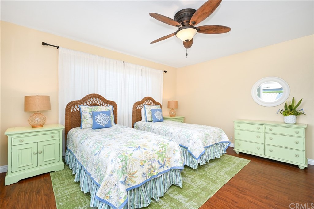 5100 Seashore Drive Newport Beach, CA 92663 - Photo 23 of 67 a bedroom with a bed a lamp and a dresser