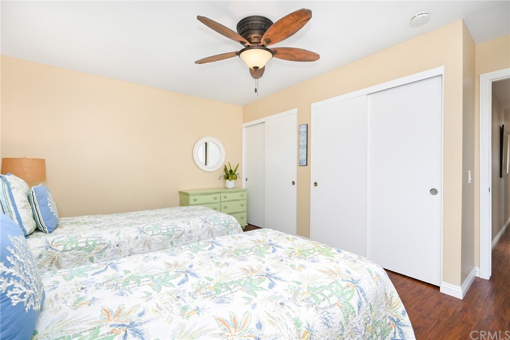 5100 Seashore Drive Newport Beach, CA 92663 - Photo 24 of 67 a bedroom with a bed and a chandelier