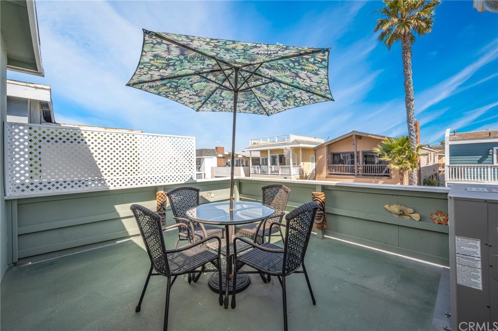 5100 Seashore Drive Newport Beach, CA 92663 - Photo 31 of 67 a view of a patio with a table and chairs