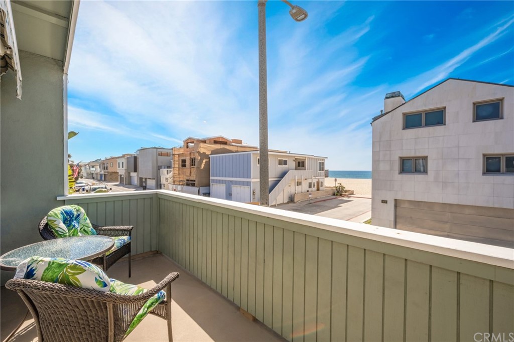 5100 Seashore Drive Newport Beach, CA 92663 - Photo 34 of 67 a balcony with furniture and a potted plant