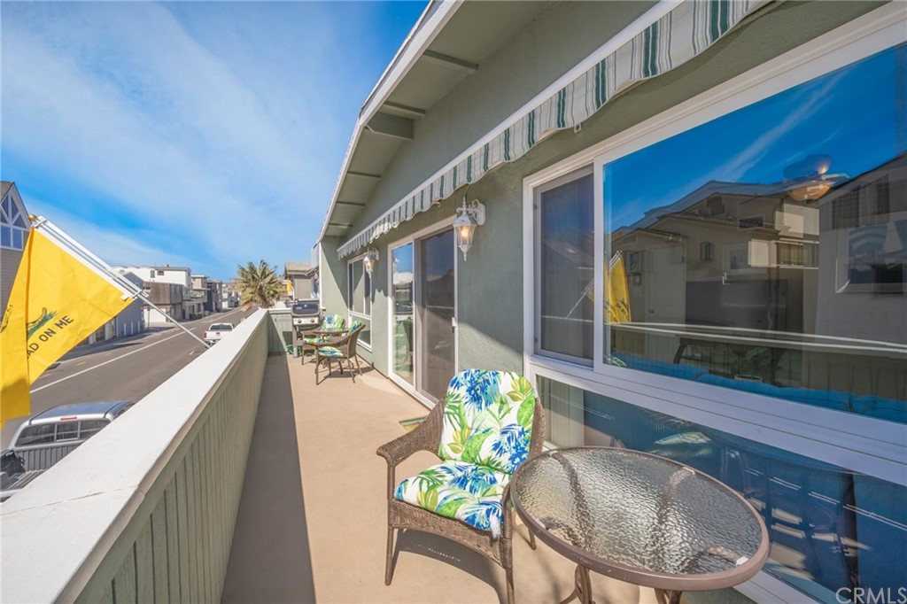 5100 Seashore Drive Newport Beach, CA 92663 - Photo 36 of 67 a balcony with furniture and a potted plant