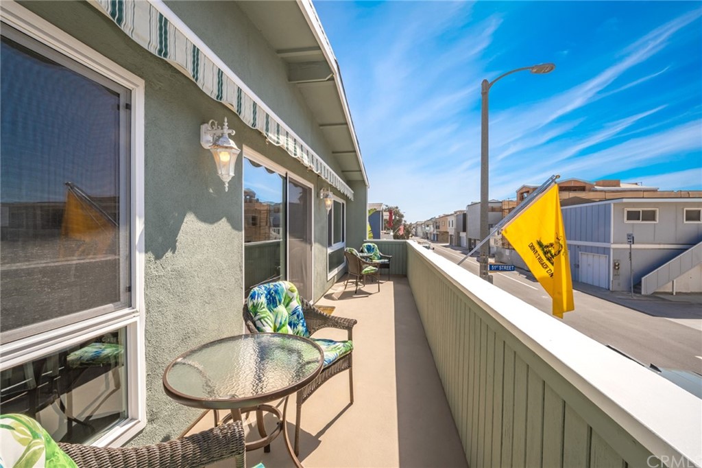 5100 Seashore Drive Newport Beach, CA 92663 - Photo 39 of 67 a balcony with table and chairs
