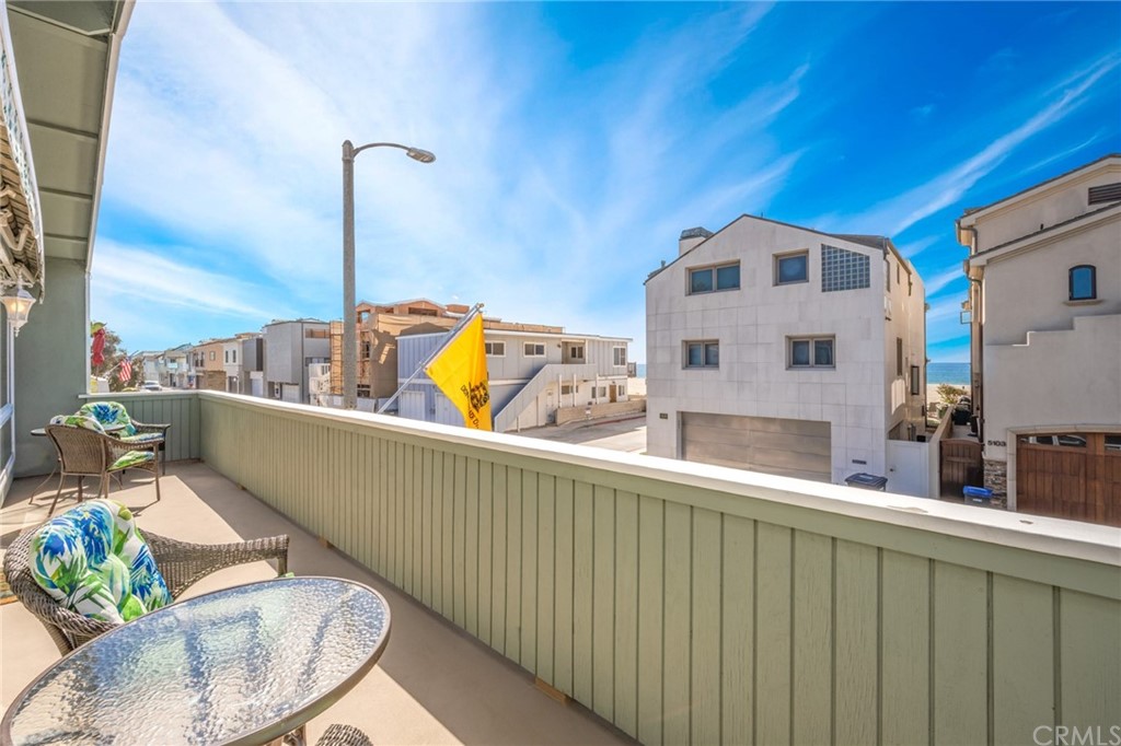 5100 Seashore Drive Newport Beach, CA 92663 - Photo 40 of 67 a view of a balcony with chair and a potted plant