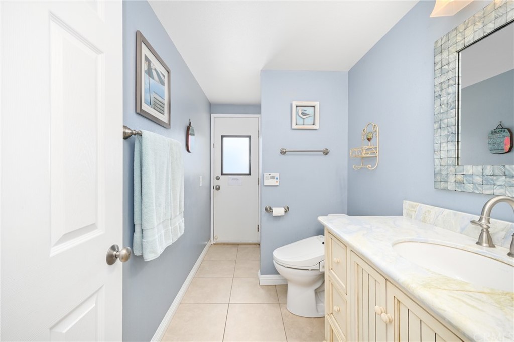 5100 Seashore Drive Newport Beach, CA 92663 - Photo 42 of 67 a bathroom with a granite countertop sink mirror vanity and toilet