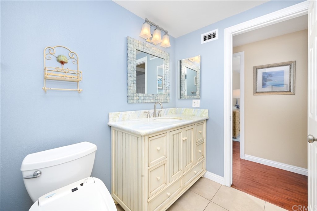 5100 Seashore Drive Newport Beach, CA 92663 - Photo 43 of 67 a bathroom with a sink a toilet and mirror
