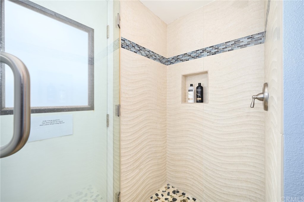 5100 Seashore Drive Newport Beach, CA 92663 - Photo 44 of 67 a bathroom with a shower and a mirror