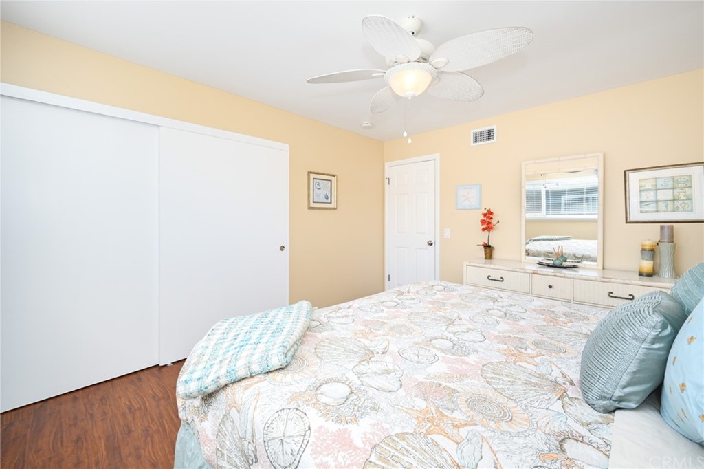 5100 Seashore Drive Newport Beach, CA 92663 - Photo 48 of 67 a spacious bedroom with a bed and a chandelier