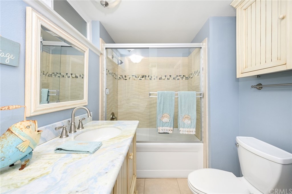 5100 Seashore Drive Newport Beach, CA 92663 - Photo 51 of 67 a bathroom with a granite countertop sink mirror vanity and toilet