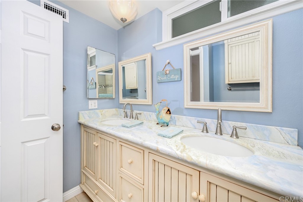 5100 Seashore Drive Newport Beach, CA 92663 - Photo 52 of 67 a bathroom with a granite countertop sink and a mirror