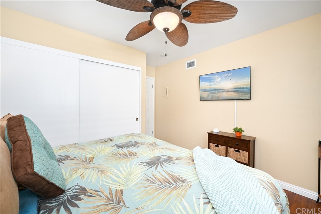 5100 Seashore Drive Newport Beach, CA 92663 - Photo 54 of 67 a bedroom with a bed and a chandelier