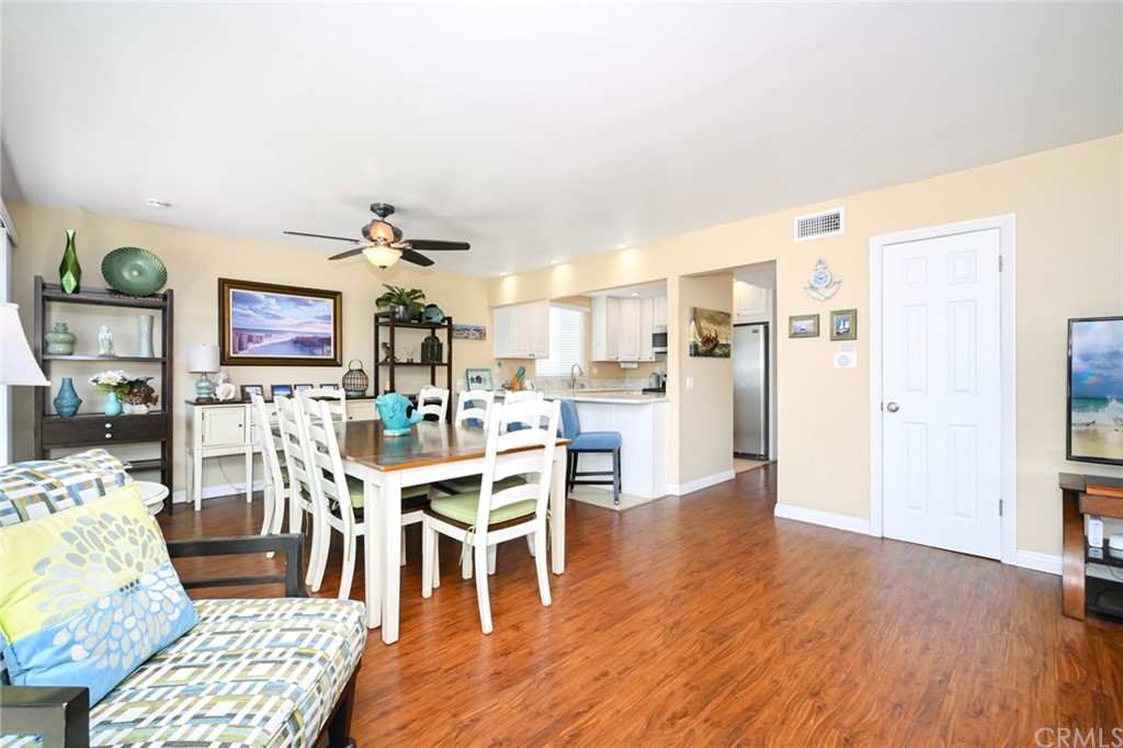 5100 Seashore Drive Newport Beach, CA 92663 - Photo 10 of 67 a view of a dining room with furniture and wooden floor